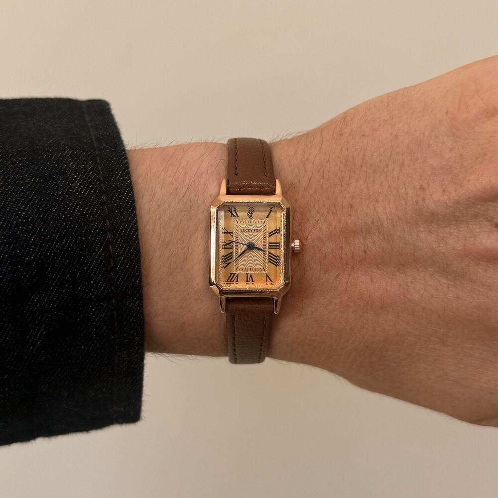 2000s vintage style rectangular gold luxury watch with leather band